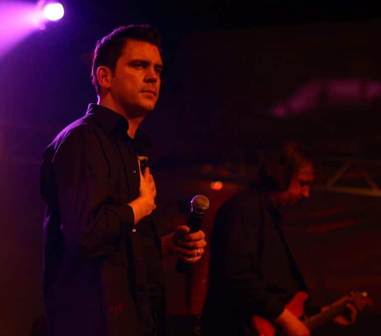 - Aufnahmeszene des Abenteuersland Coverbands bei einem Live-Konzert mit stimmungsvoller Beleuchtung.